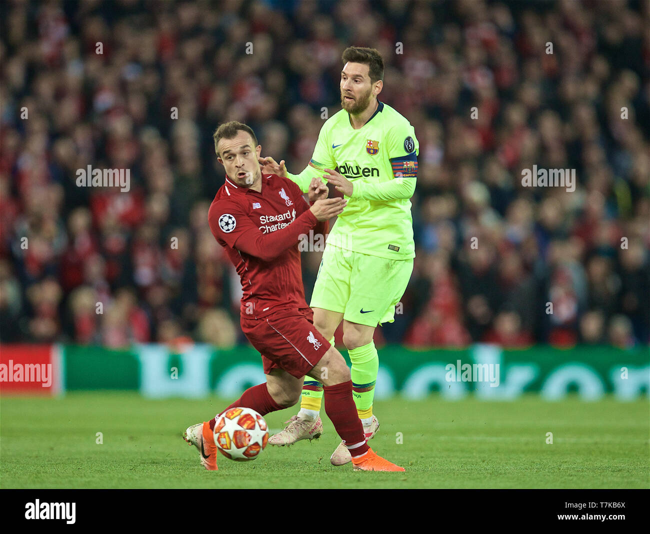 Liverpool. 8th May, 2019. Liverpool's Xherdan Shaqiri (L) vies with FC Barcelona's Lionel Messi during the UEFA Champions League Semi-Final second Leg match between Liverpool FC and FC Barcelona at Anfield in Liverpool, Britain on May 7, 2019. Liverpool won 4-3 on aggregate and reached the final. Credit: Xinhua/Alamy Live News Stock Photo