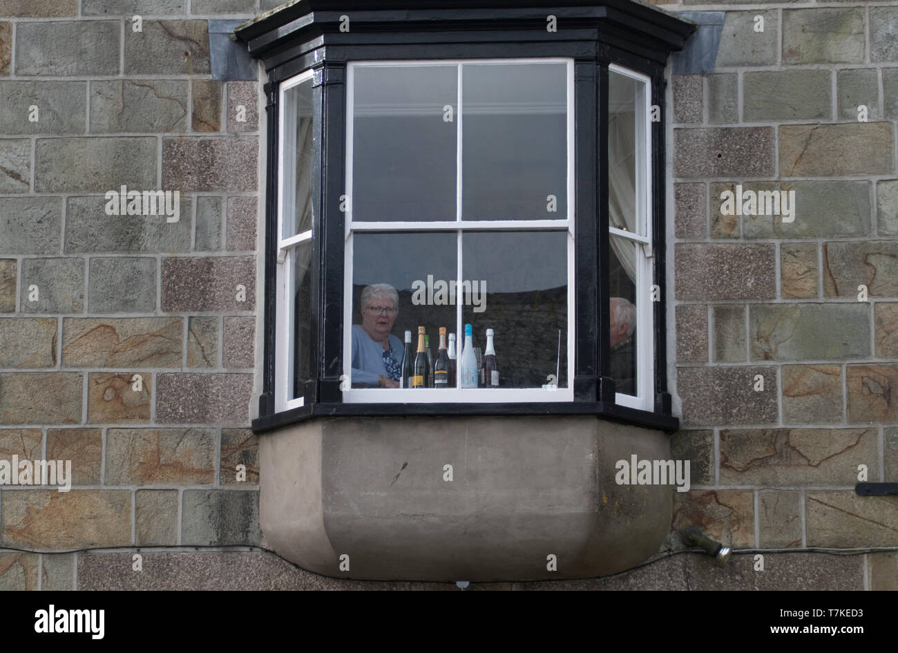 Helston, Cornwall, UK. 8th May 2019. Helston Flora day annual spring festival. A resident with prime viewing location on the main street getting ready for the days festivities.. Credit Simon Maycock / Alamy Live News. Stock Photo