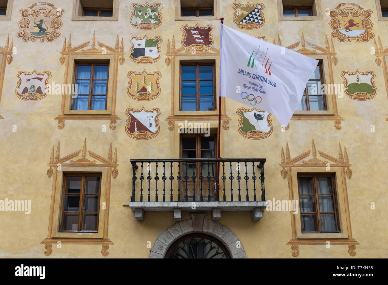 Flag of Milano Cortina candidate city for Olympic Winter Games 2026 on a historic building in Cortina D’Ampezzo, Italy Stock Photo
