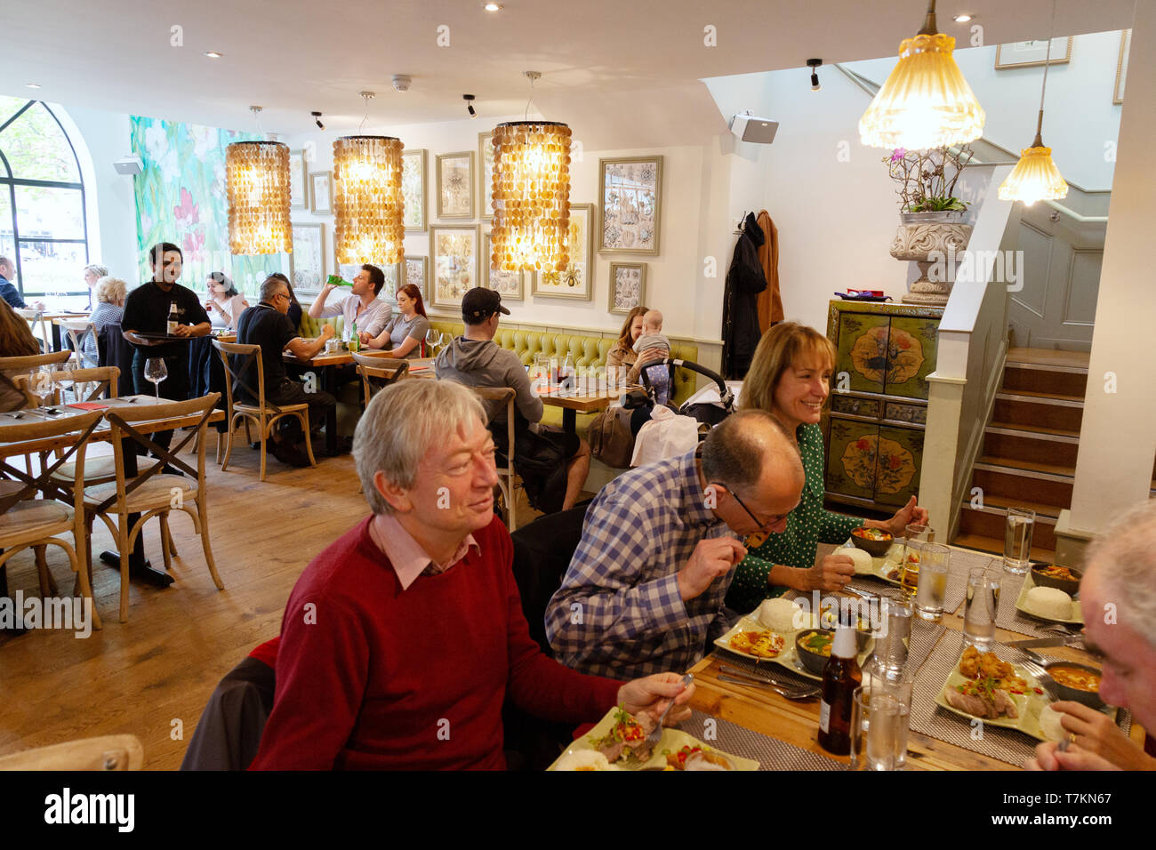 The Giggling Squid Thai restaurant - customers eating in the interior of the Giggling Squid restaurant, Harpenden, Hertfordshire UK Stock Photo