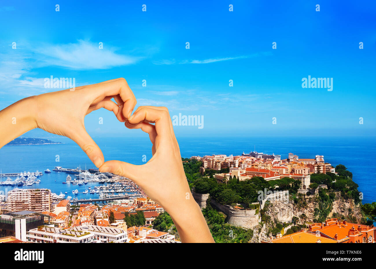 Red love heart and on background old city peninsula with prince palace in Monaco, tiny little country in Mediterranean Europe Stock Photo