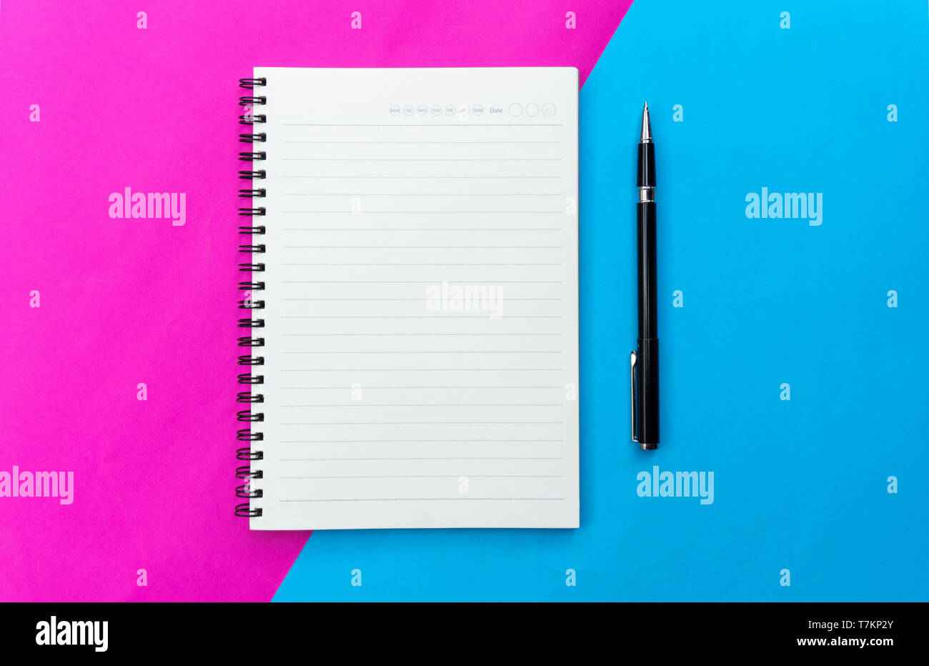 Top view blank notebook and black pen for mockup flat lay on blue and pink background. Stock Photo