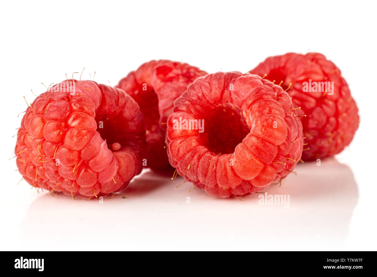 Group of four whole fresh red raspberry isolated on white background ...