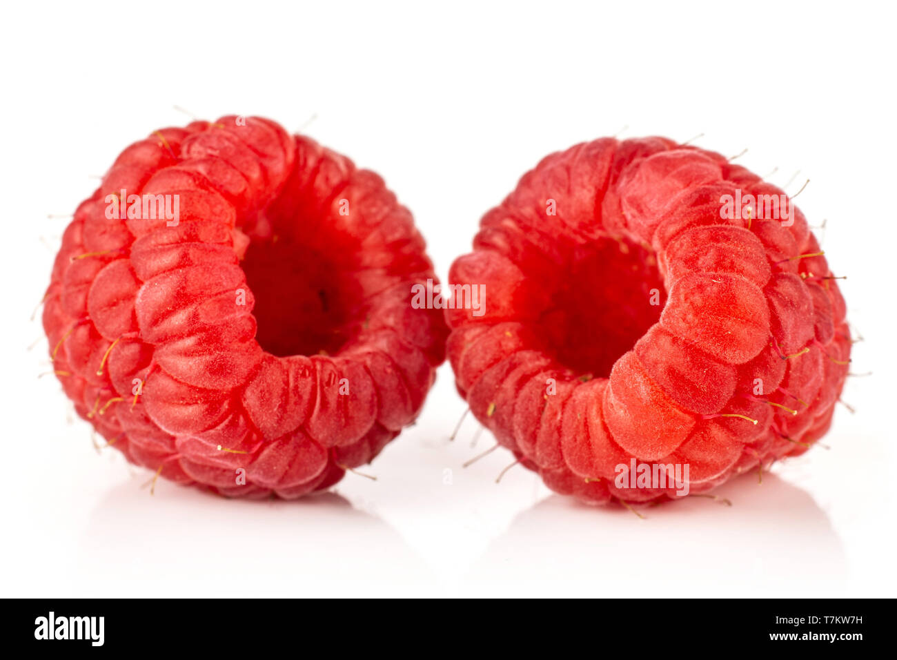 Closeup of two whole fresh red raspberry isolated on white background ...