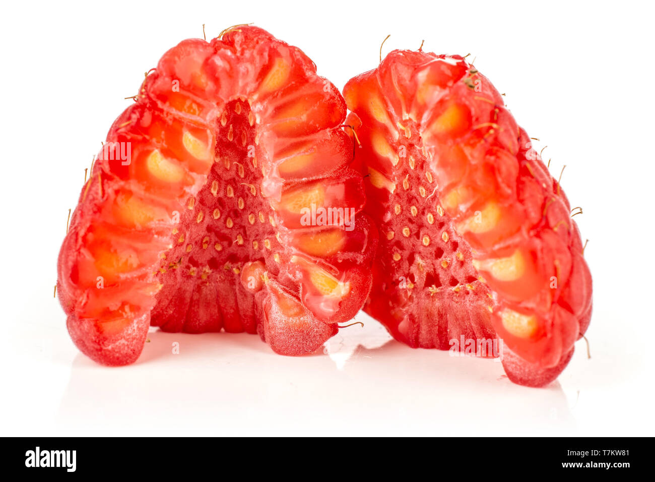 Group of two halves of fresh red raspberry cross section isolated on white background Stock Photo