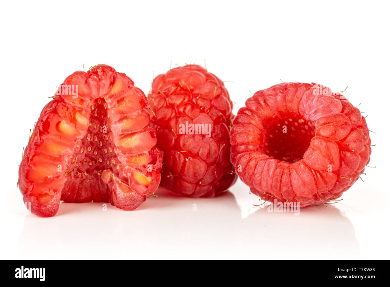 Group of two whole one half of fresh red raspberry cross section isolated on white background Stock Photo