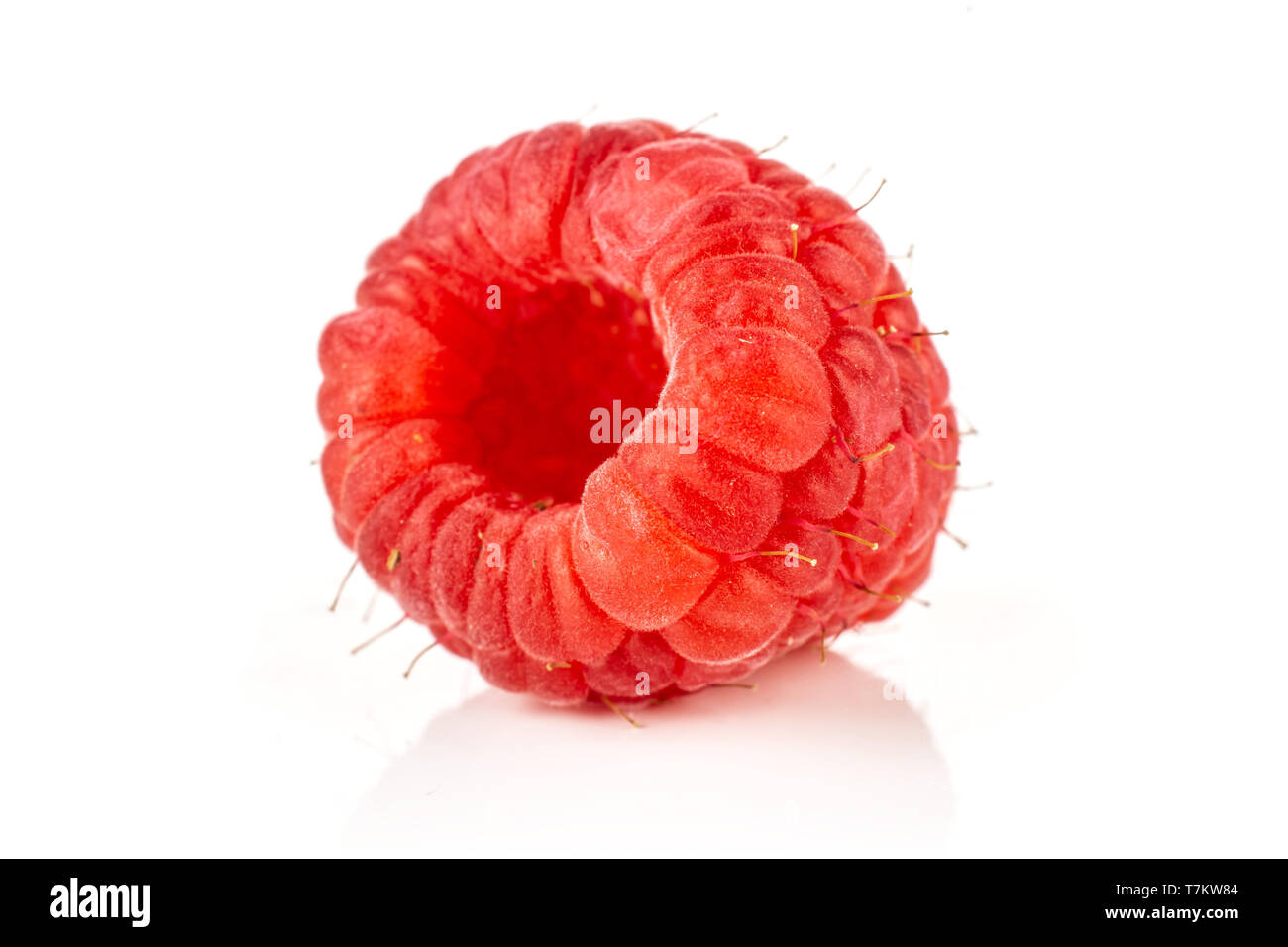 Closeup of one whole fresh red raspberry isolated on white background ...