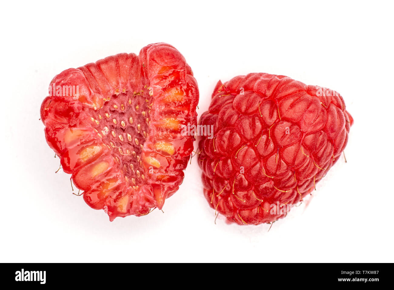 Group of one whole one half of fresh red raspberry cross section flatlay isolated on white background Stock Photo