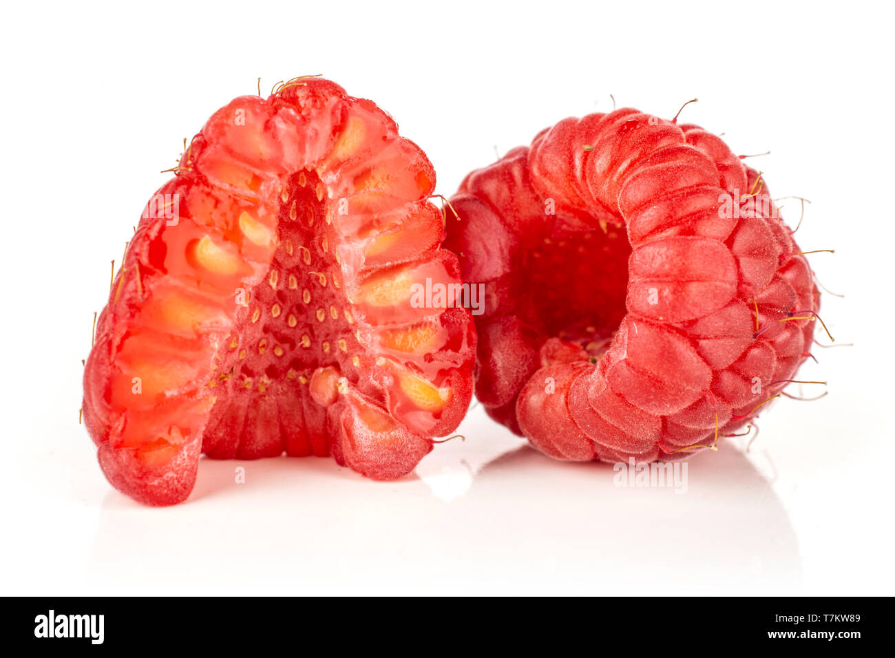 Group of one whole one half of fresh red raspberry cross section isolated on white background Stock Photo