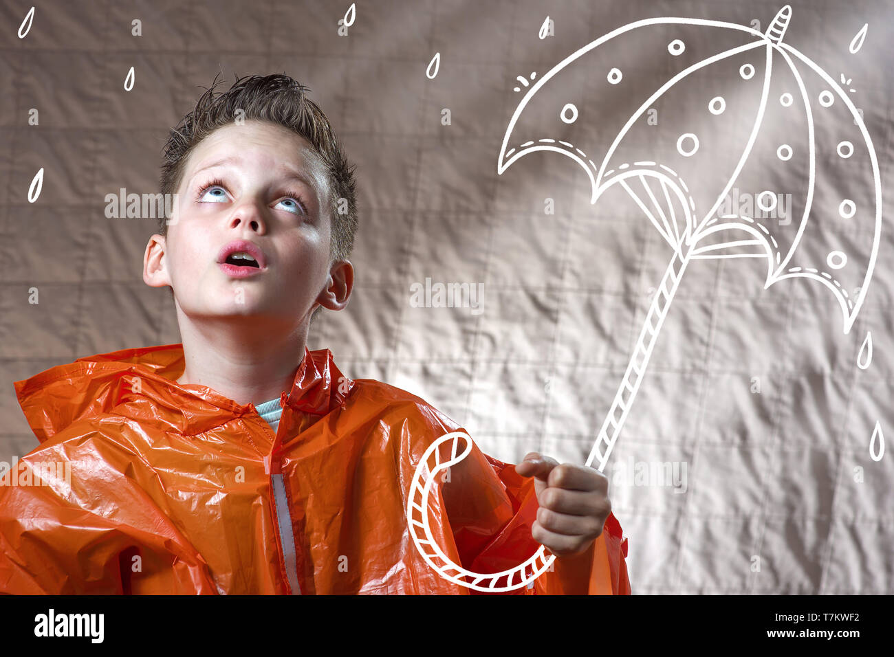a boy in an orange raincoat and with a painted umbrella stands in the