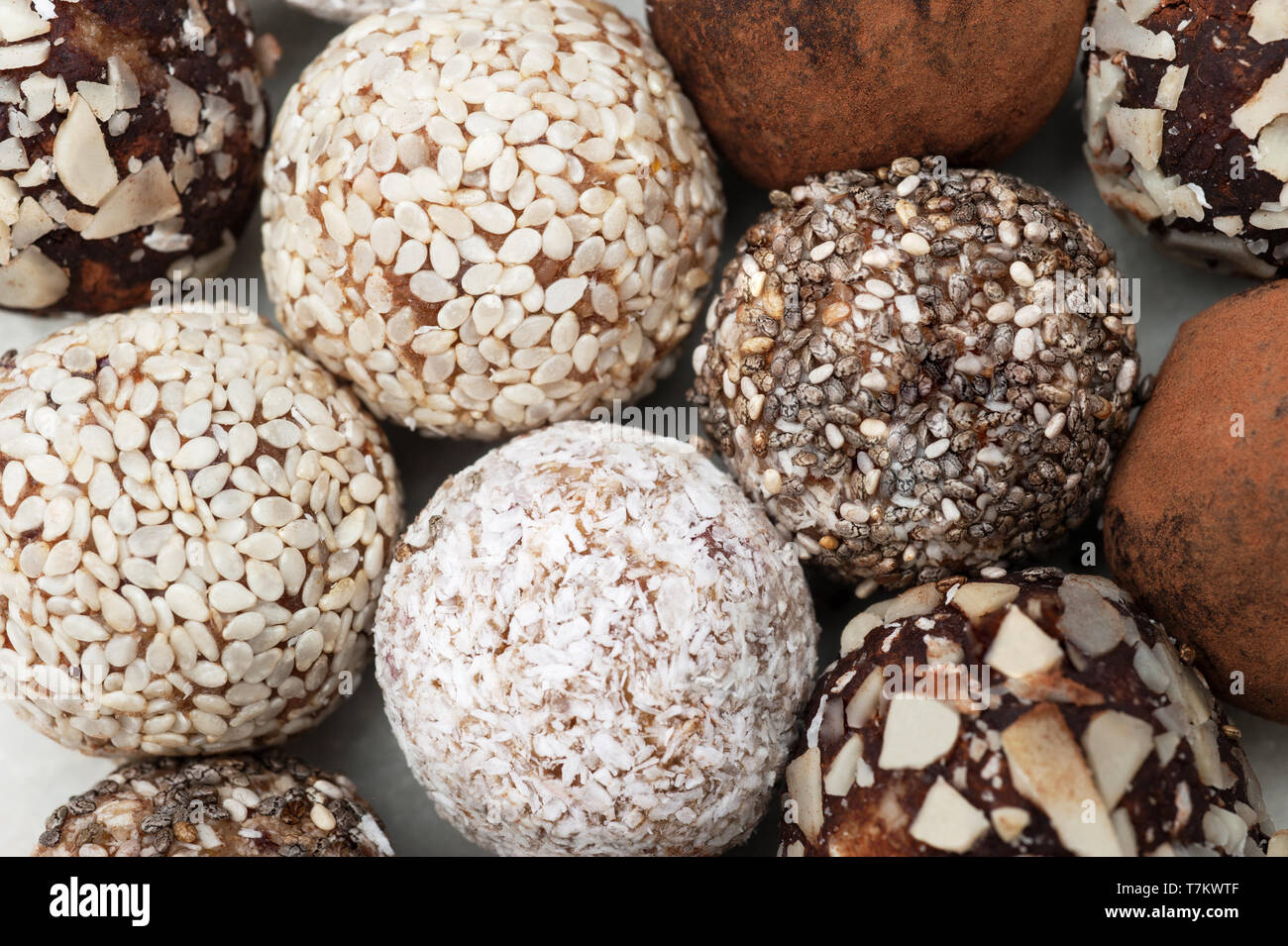 Energy ball with dried fruits, sesame, linen, walnuts ,coconut flakes. Close up, macro,vegan homemade candy.Background macro texture.Selective focus. Stock Photo