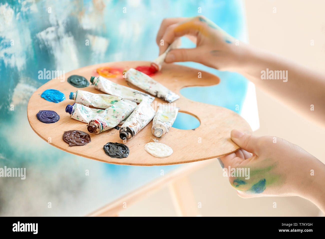 Female artist with palette and paints in workshop, closeup Stock Photo ...