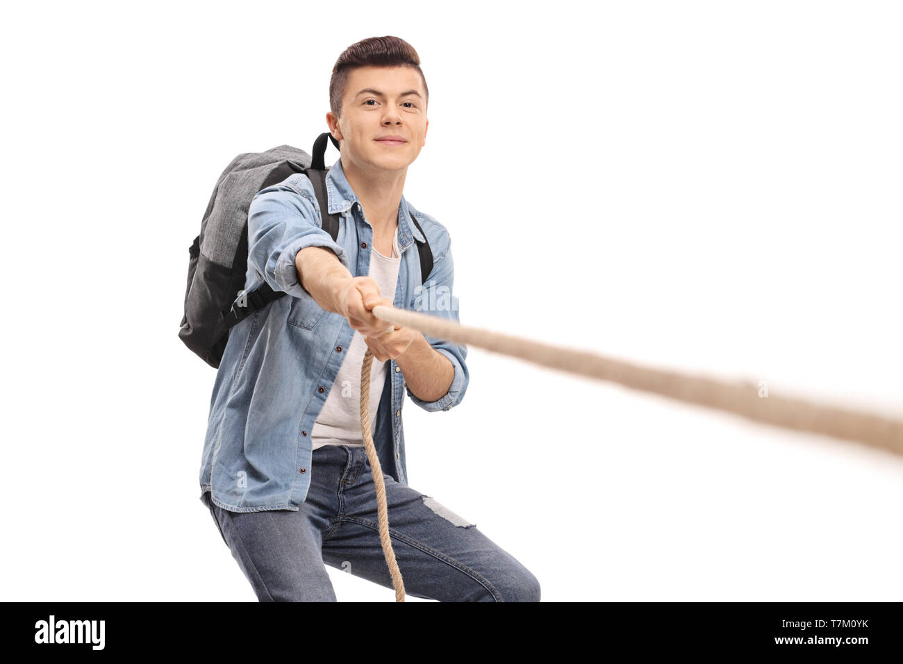 Male student pulling a rope isolated on white background Stock Photo