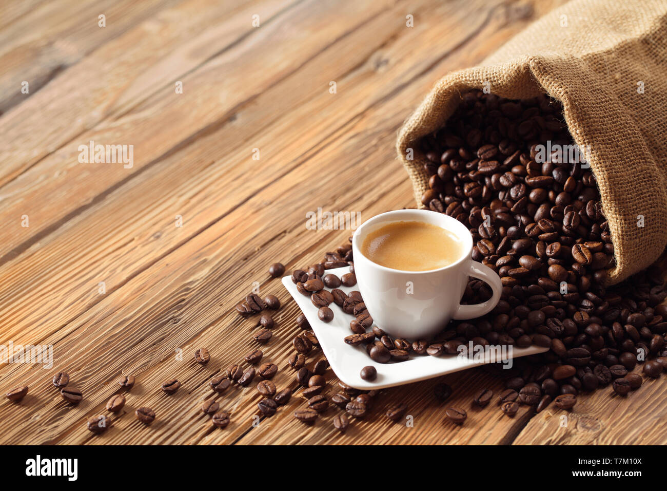 Coffee cup espresso with coffee beans and wooden background Stock Photo