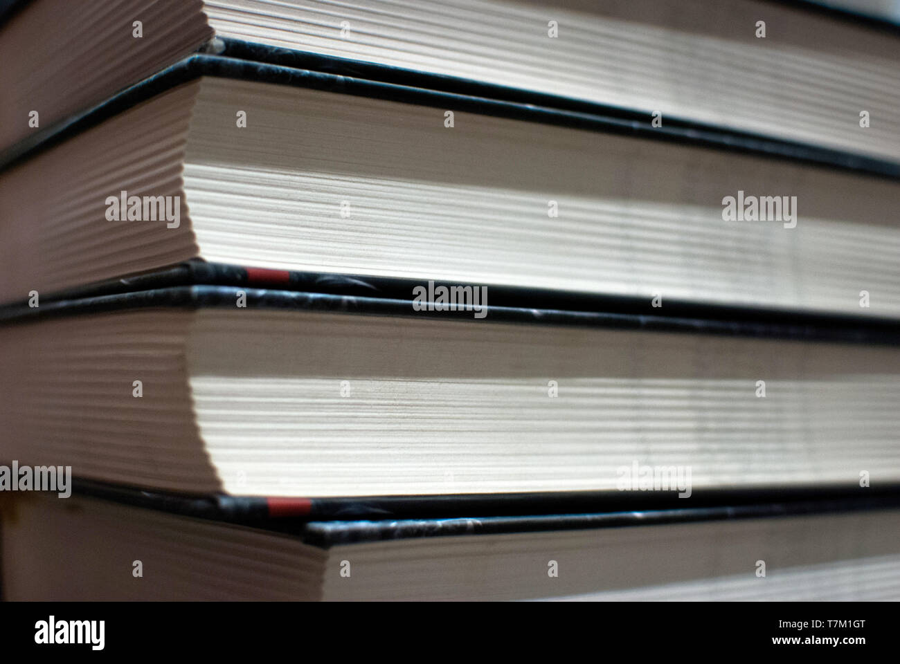 Pile of paperback book ends stacked background. Stock Photo