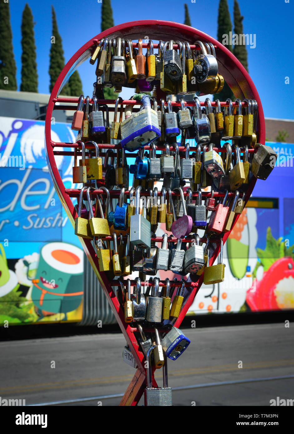 A collection of padlocks displayed on historic 4th Avenue are known worldwide as Love locks, symbolizing unbreakable love, in Tucson, AZ Stock Photo