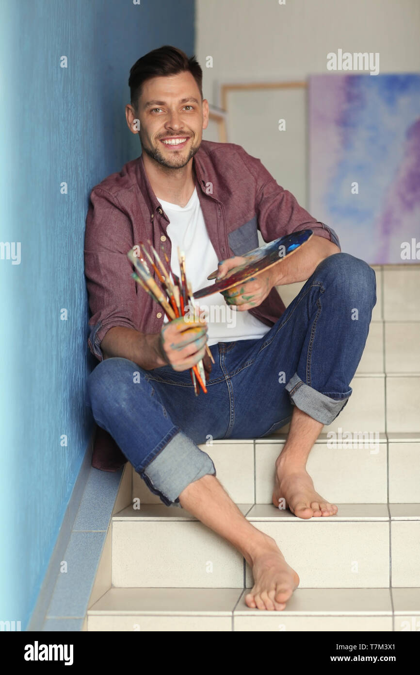 Man Using Art Tools Male artist with paint tools and palette in workshop Stock Photo - Alamy
