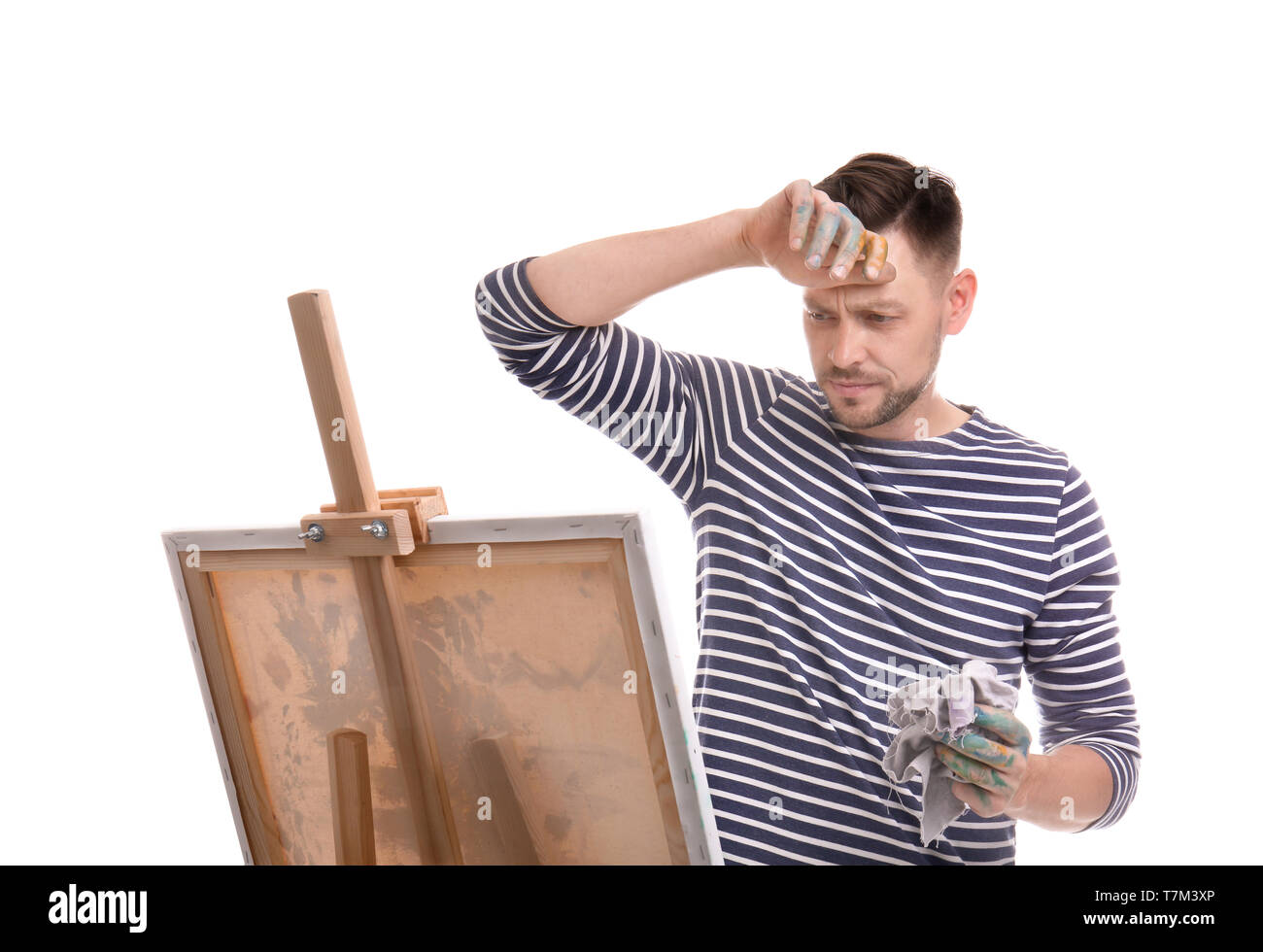 Tired male artist with rag near easel on white background Stock Photo ...