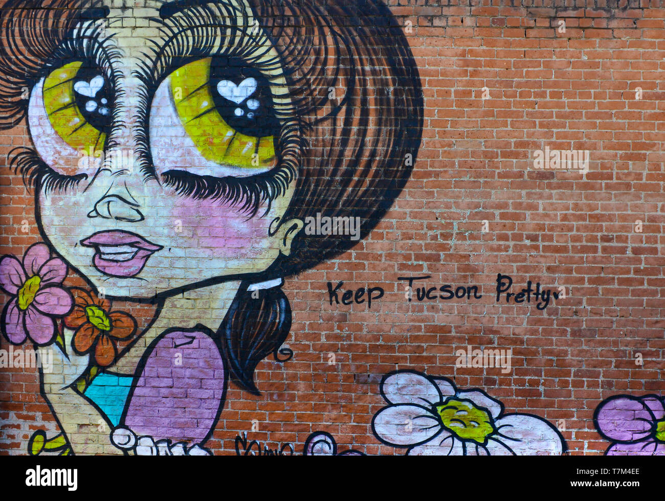 A fun mural of cartoon like big eyed girl with graffiti: Keep Tucson Pretty,  on an historic 4th Avenue brick building in downtown Tucson, AZ Stock Photo