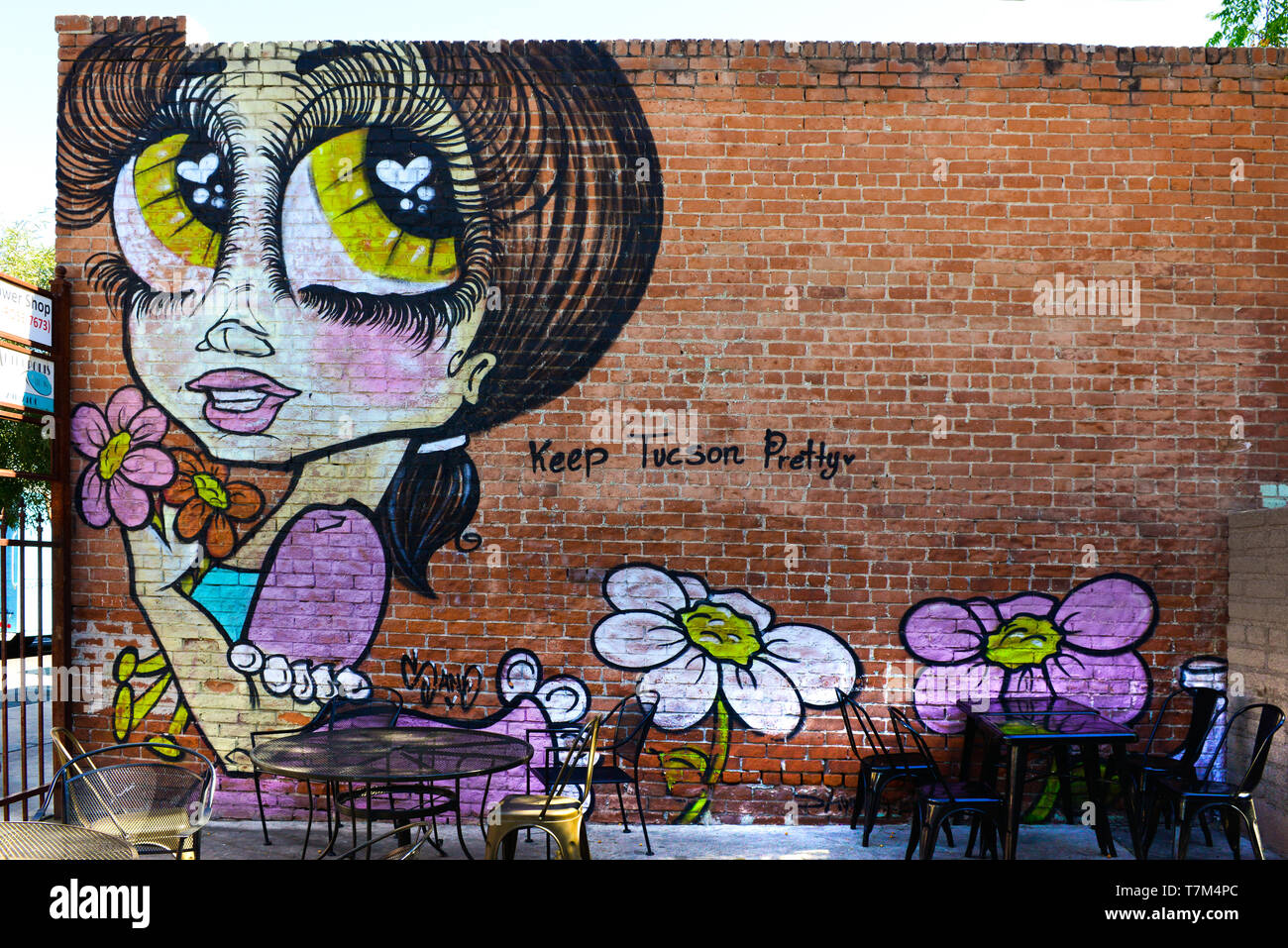 A fun mural of cartoon like big eyed girl with graffiti: Keep Tucson Pretty,  on an historic 4th Avenue brick building in downtown Tucson, AZ Stock Photo