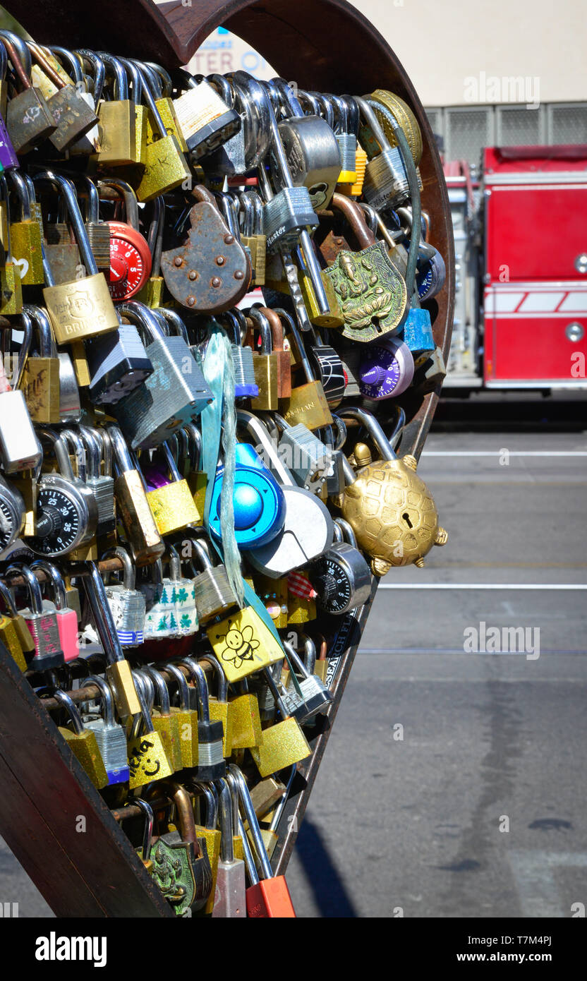 A collection of padlocks displayed on historic 4th Avenue are known worldwide as Love locks, symbolizing unbreakable love, in Tucson, AZ Stock Photo