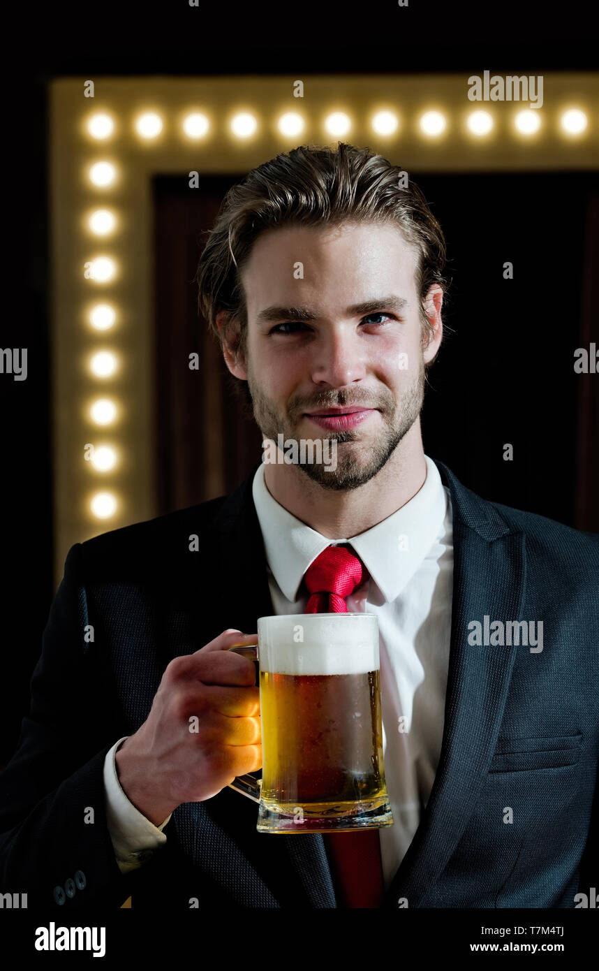 smiling man or businessman hold beer glass, meeting and relax Stock Photo