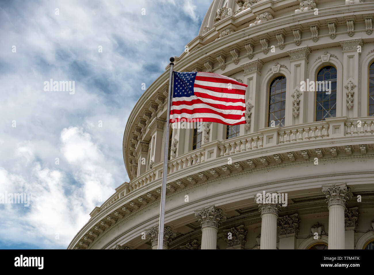 Washington DC capitol with waving flag detail on cloudy sky Stock Photo ...