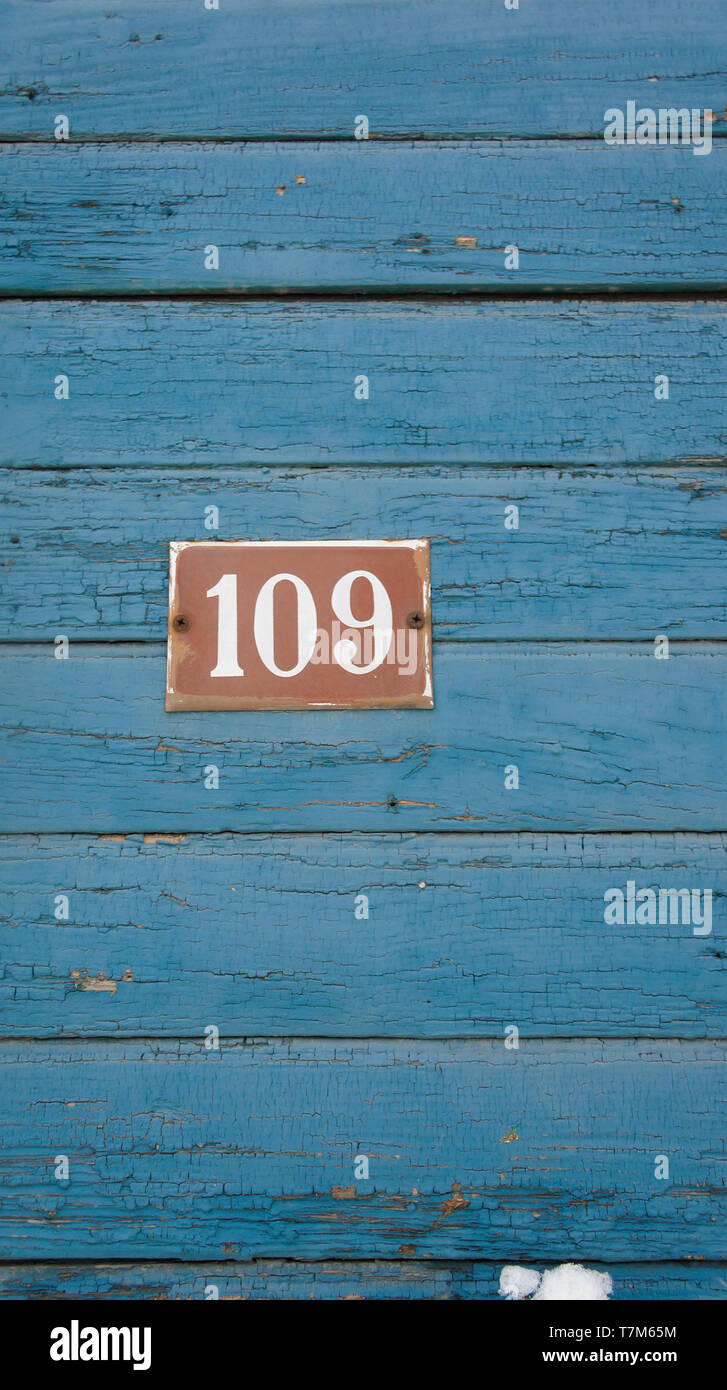 Number 109 on Blue painted wood Stock Photo