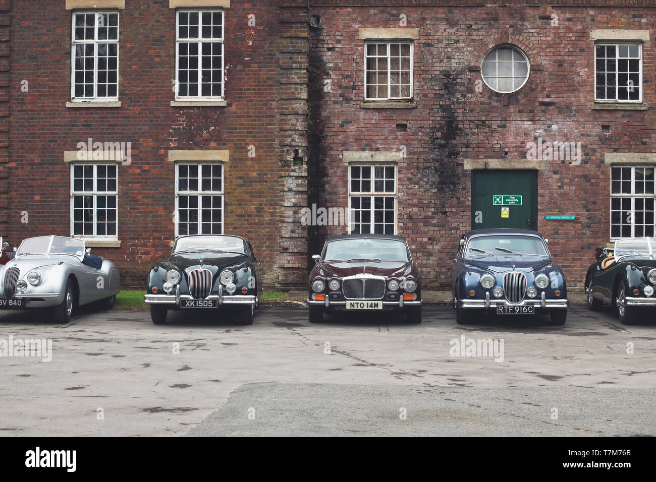 Vintage Jaguar and Daimler cars at Bicester Heritage Centre ‘Drive it day’. Bicester, Oxfordshire, England. Vintage filter applied Stock Photo