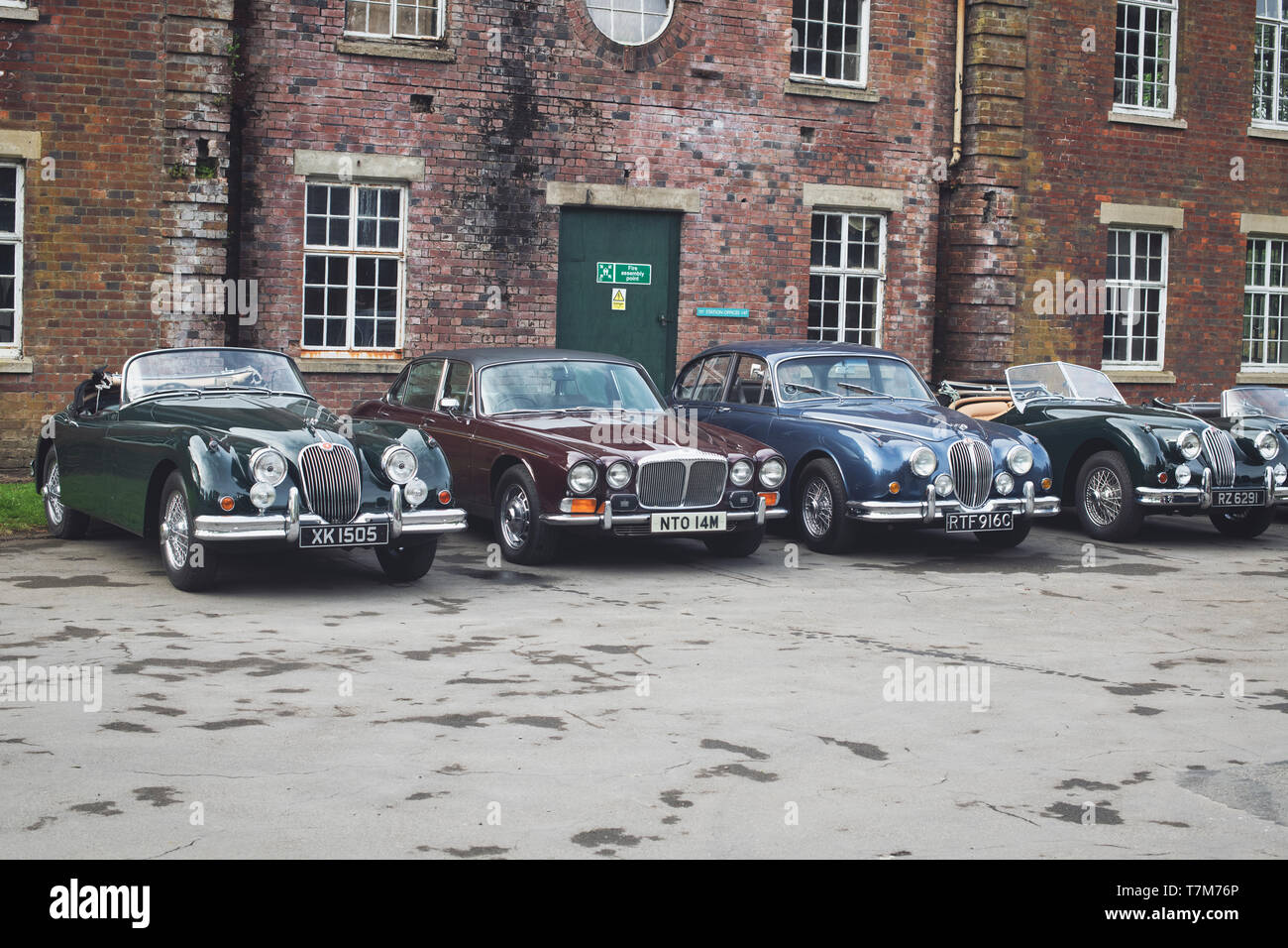 Vintage Jaguar and Daimler cars at Bicester Heritage Centre ‘Drive it day’. Bicester, Oxfordshire, England. Vintage filter applied Stock Photo