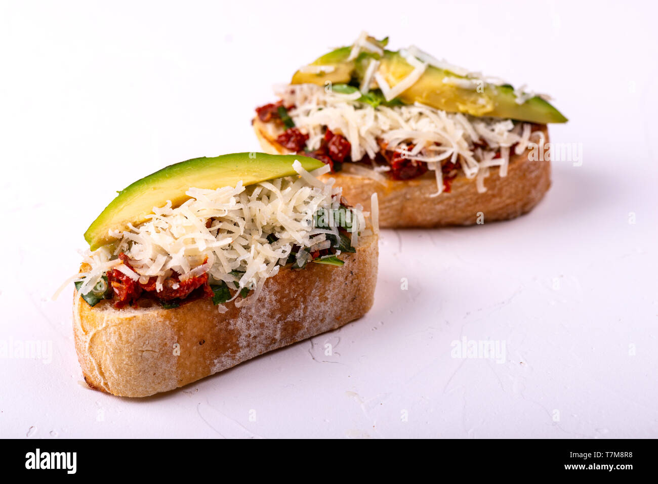 Delicious Italian antipasti bruschetta on white background. Macro Stock