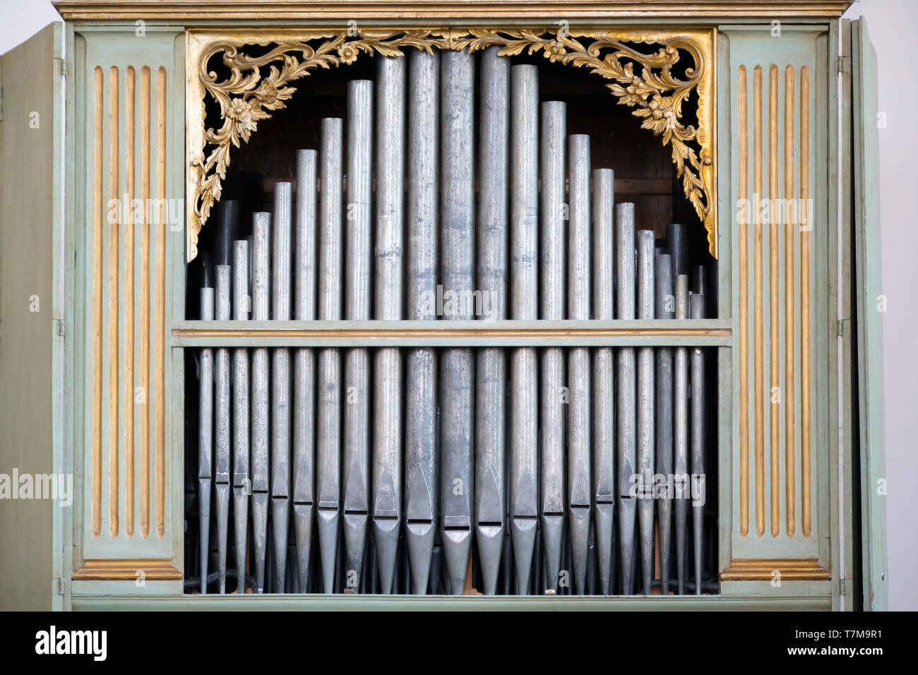 Old, silver organ pipes in a church used for playing sacred music. Many air pipes, sound tubes in the cathedral Stock Photo