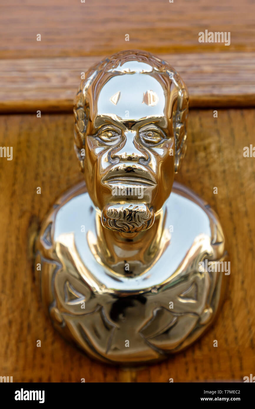 A unique brass exterior door handle photographed in Venice, Italy Stock