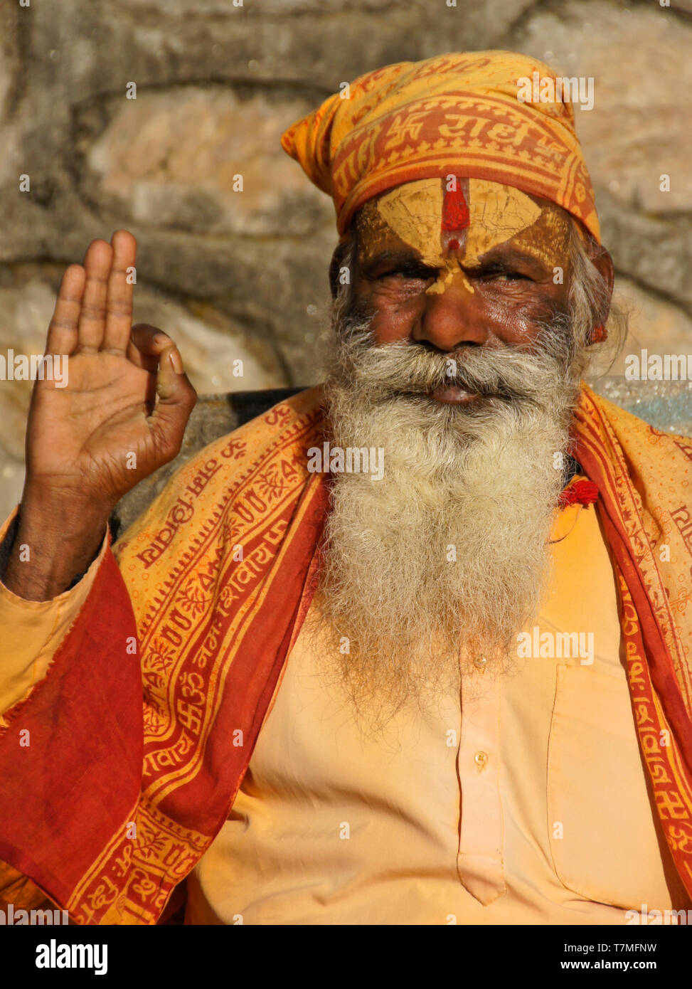 Portrait of a sadhu (holy man) with painted face, clad in orange robes, Pashupatinath Hindu temple, Kathmandu Valley, Nepal Stock Photo