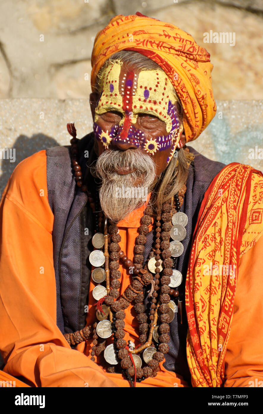 Portrait of a sadhu (holy man) with painted face, clad in orange robes, Pashupatinath Hindu temple, Kathmandu Valley, Nepal Stock Photo
