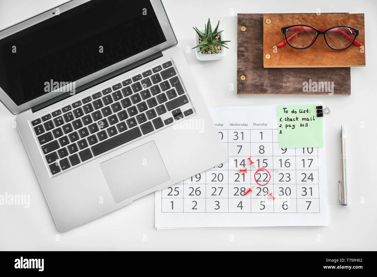 Calendar with notes and laptop on white background Stock Photo - Alamy