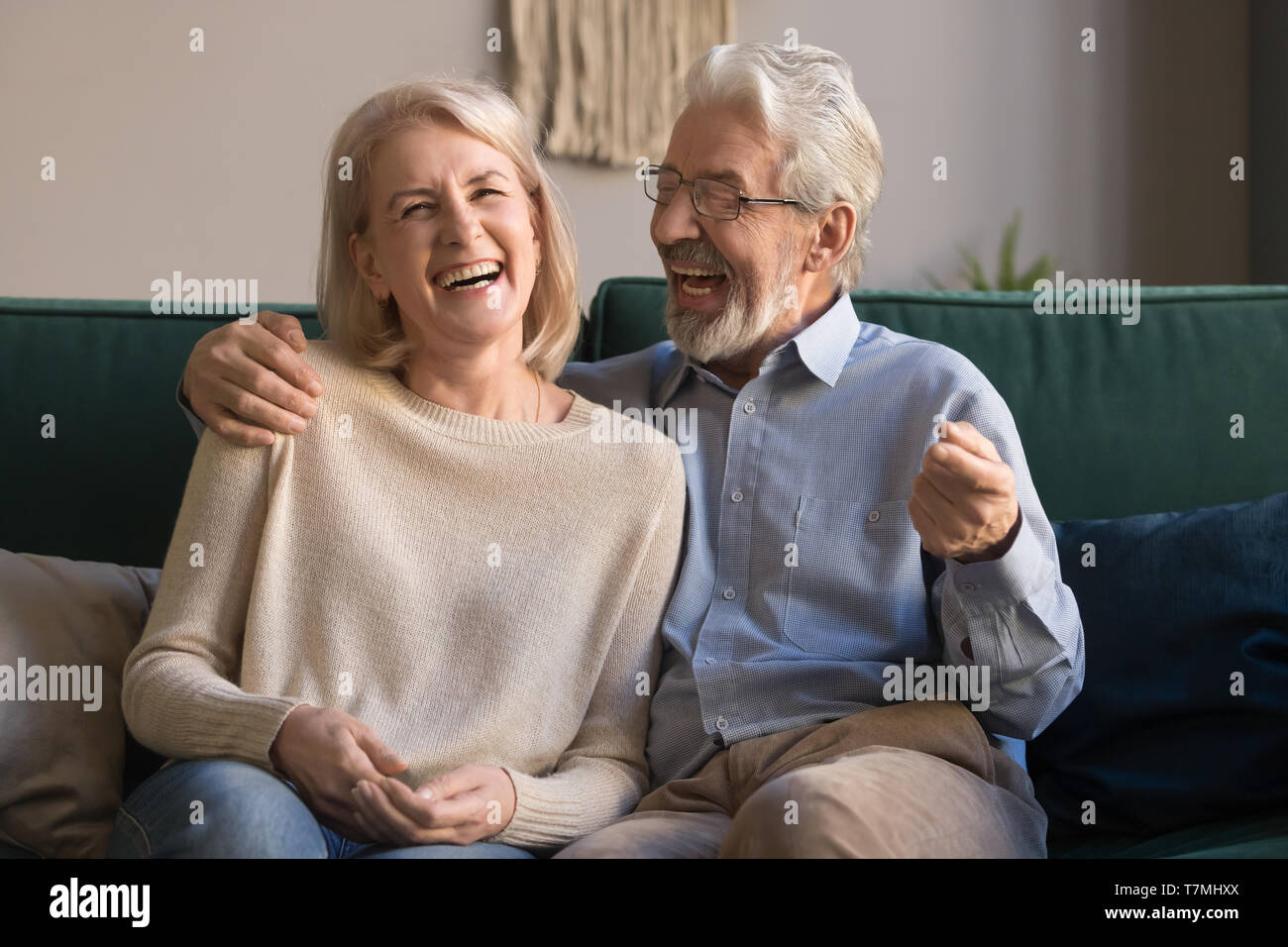 Portrait of middle aged laughing man and woman at home Stock Photo