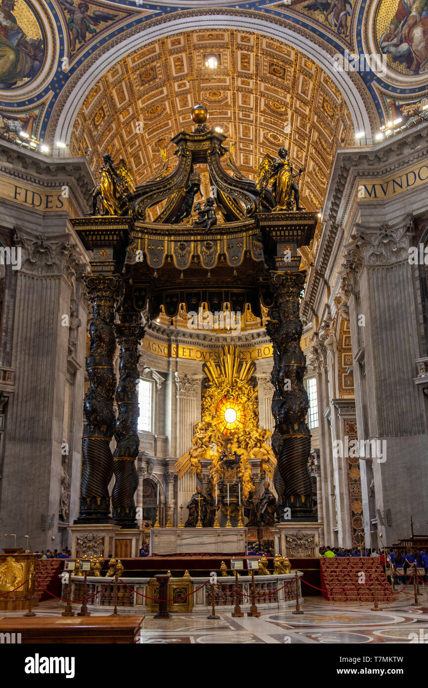 The altar with Bernini's baldacchino. Interior of The Papal Basilica of St. Peter in the Vatican, or simply St. Peter's Basilica, Rome, Italy Stock Photo