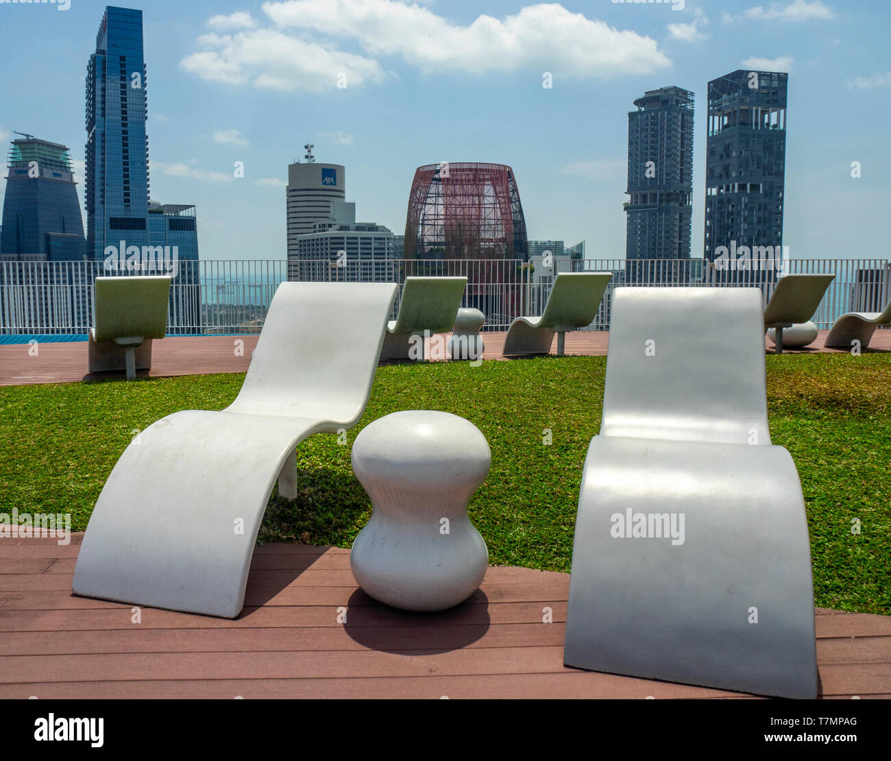 Outdoor sunlounger furniture on the 50th floor sky garden viewing platform at Pinnacle@Duxton apartment complex Singapore. Stock Photo