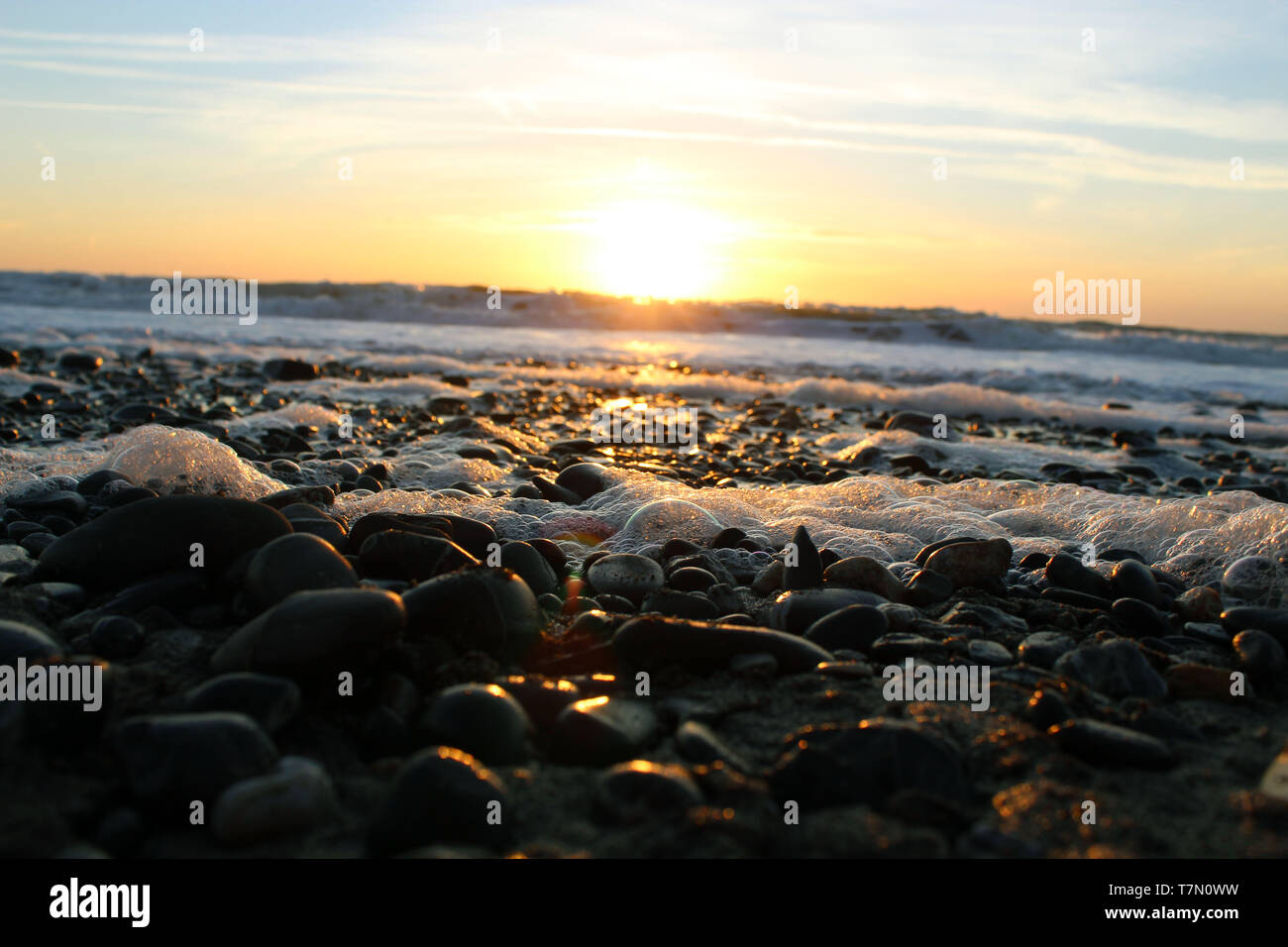 Sunset on the beach Stock Photo - Alamy