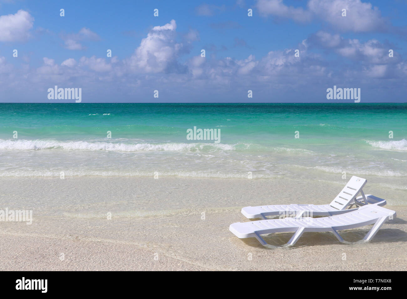 Sun beds on paradise beach Stock Photo