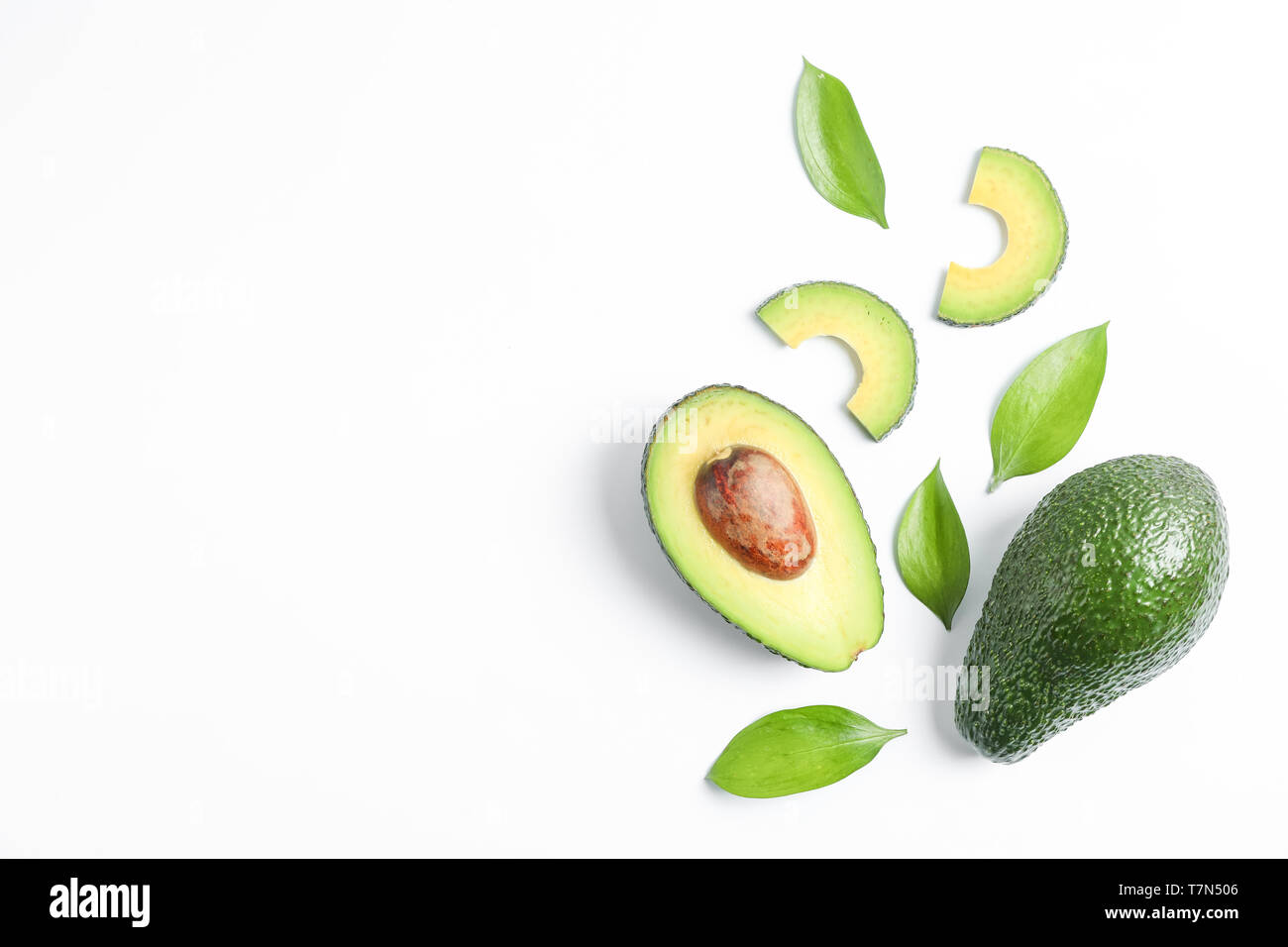 Flat lay composition with ripe avocados on white background, space for ...