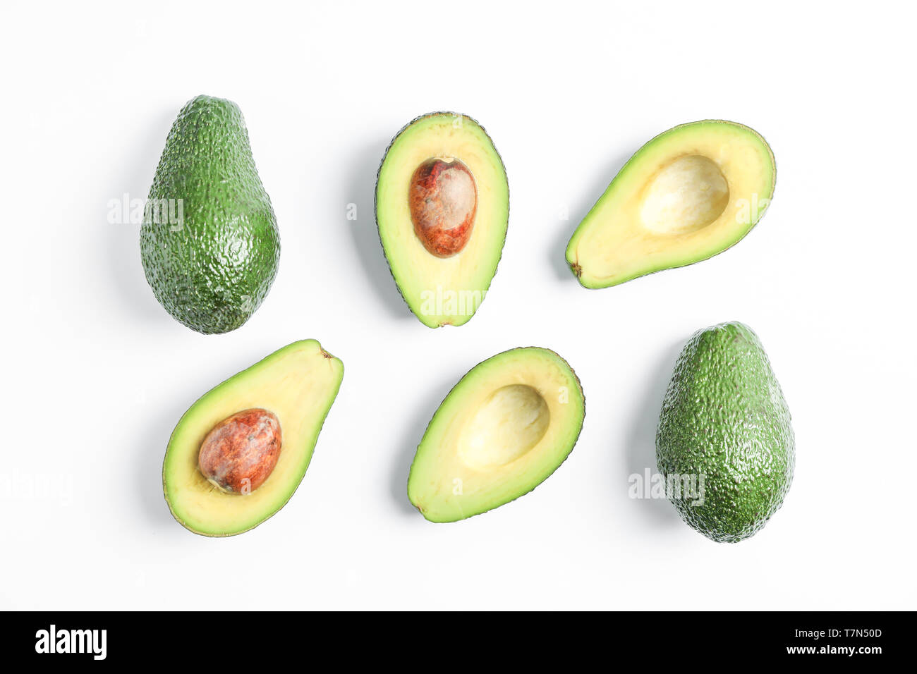Flat lay composition with ripe avocados on white background, space for ...