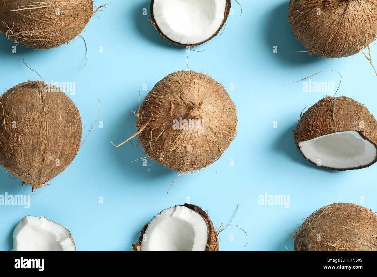 Flat lay composition with coconuts on color background Stock Photo