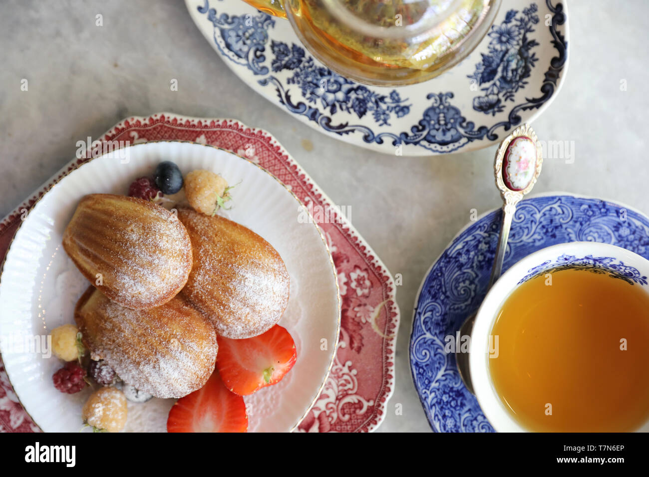 Madeleines , French sweet dessert with fruits and tea Stock Photo
