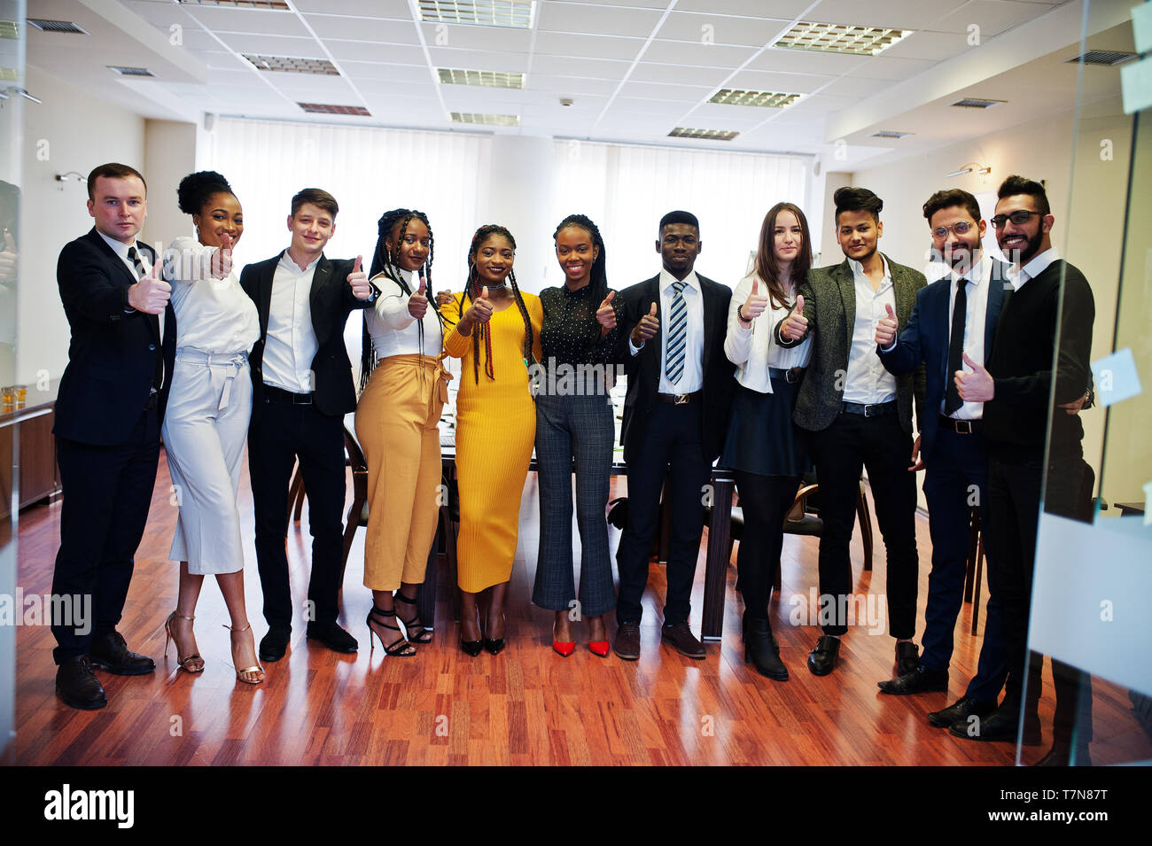 Large group of eleven multiracial business people standing at office