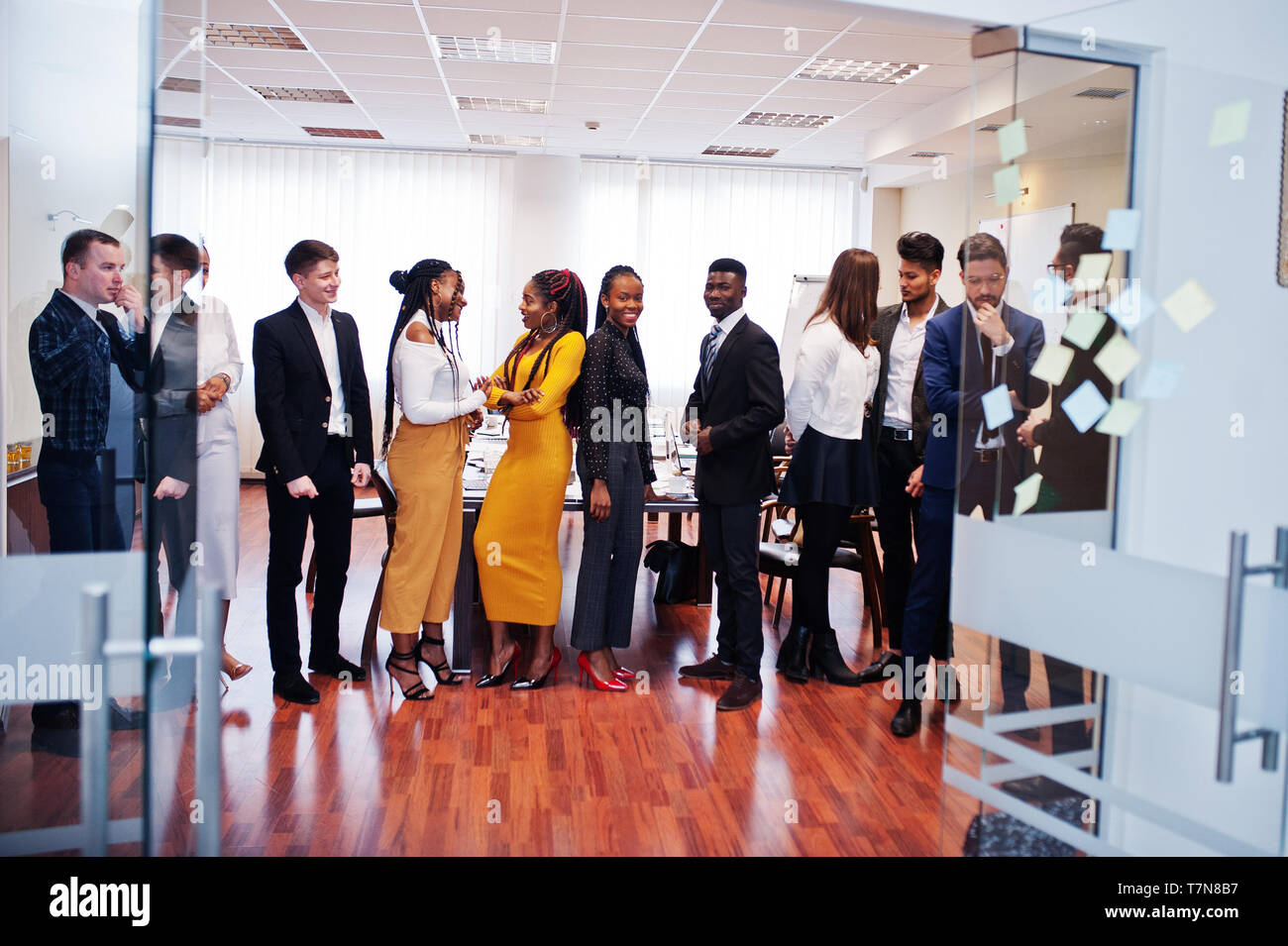 Large group of eleven multiracial business people standing at office