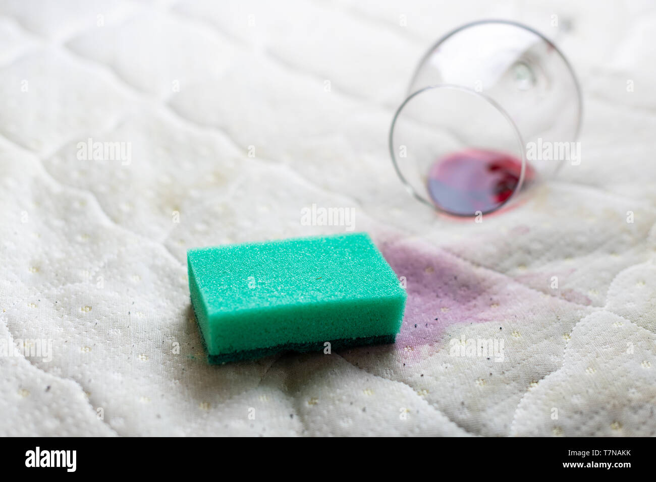 Sponge cleaning wine stain. Dropped wineglass. Spilled wine on white
