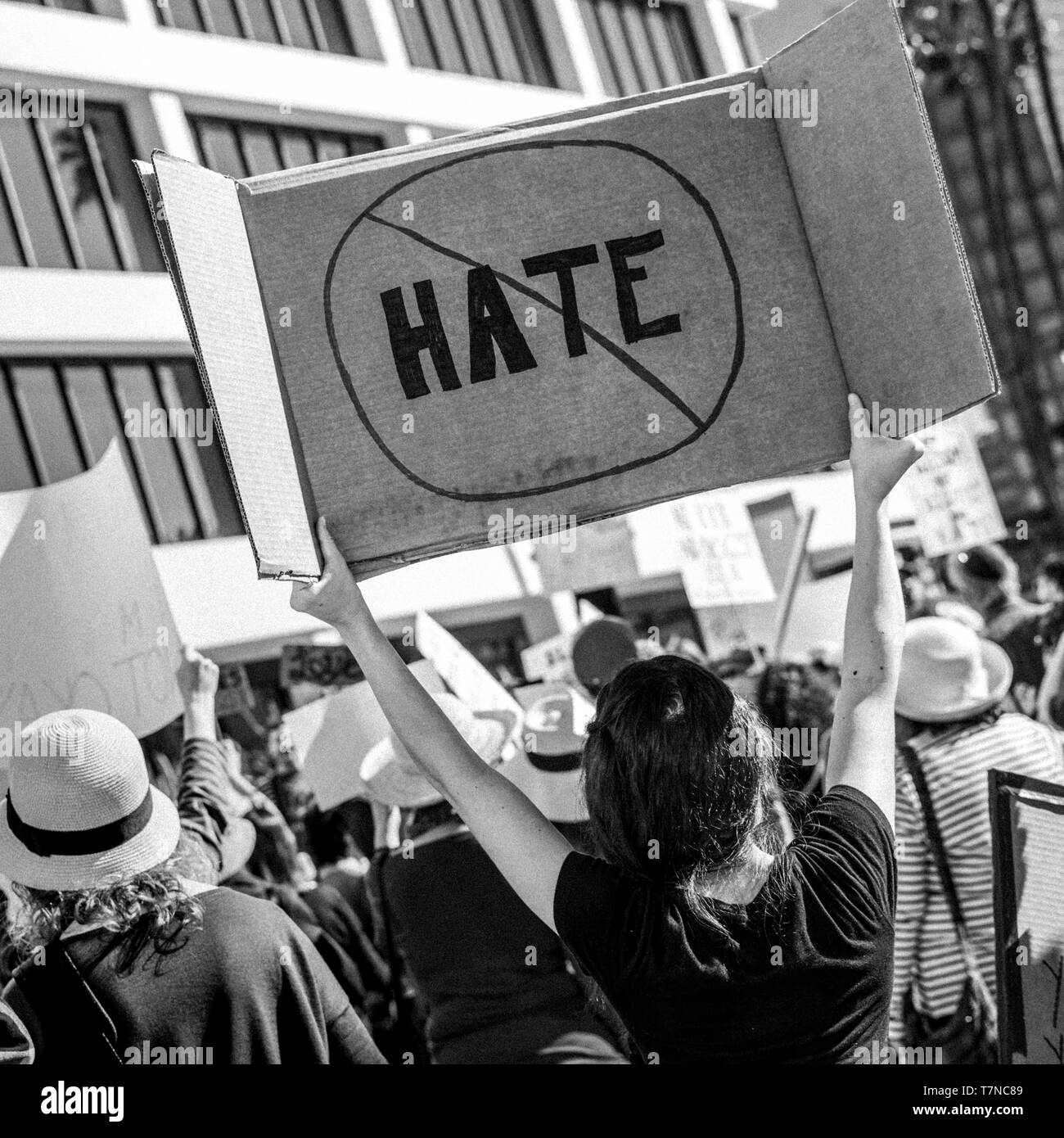 a white woman holding a 'No Hate' sign calling for equality between different elements  of the American community during a remonstration at  Los Angel Stock Photo