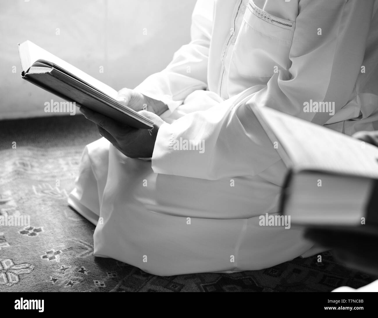 A muslim kid reciting Al-Quran - Image - black and white Stock Photo